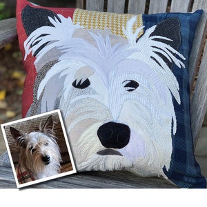 May include: Square decorative pillow featuring a detailed applique of a white dog's face. The pillow has a patchwork design with red, blue, and yellow patterned fabric. A small photo of the dog is in the lower left corner.