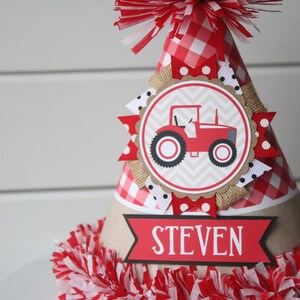 May include: Red and white gingham party hat with a red tractor illustration and the name "STEVEN" on a banner.