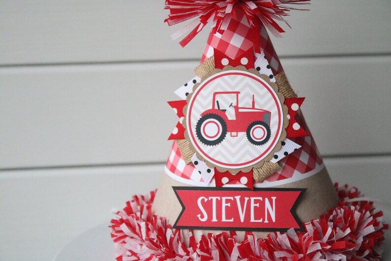 May include: Red and white gingham party hat with a red tractor illustration and the name "STEVEN" on a banner.