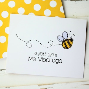 May include: A white card with a black and yellow bee illustration and the text "a note from Ms. Visaraga".