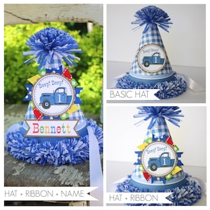 May include: A blue and white gingham party hat with a blue truck and the words "Beep! Beep!" and "1". The hat is decorated with colorful ribbons and a blue pom-pom. The hat is also personalized with the name "Bennett".