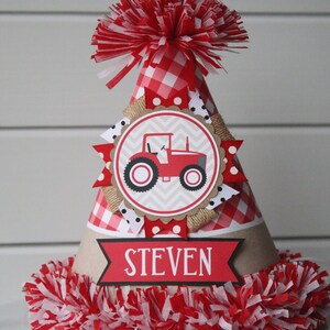 May include: Red and white gingham party hat with a red tractor illustration and the name "STEVEN" on the front.