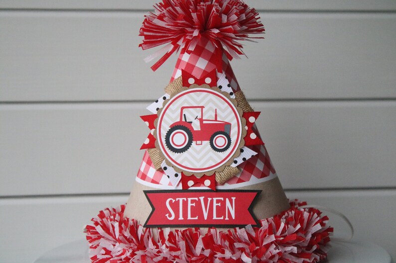 May include: Red and white gingham party hat with a red tractor illustration and the name "STEVEN" on the front.