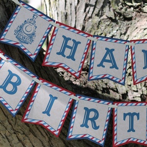 May include: A red, white, and blue banner with the words "Happy Birthday" in blue letters. The banner is decorated with a train theme.