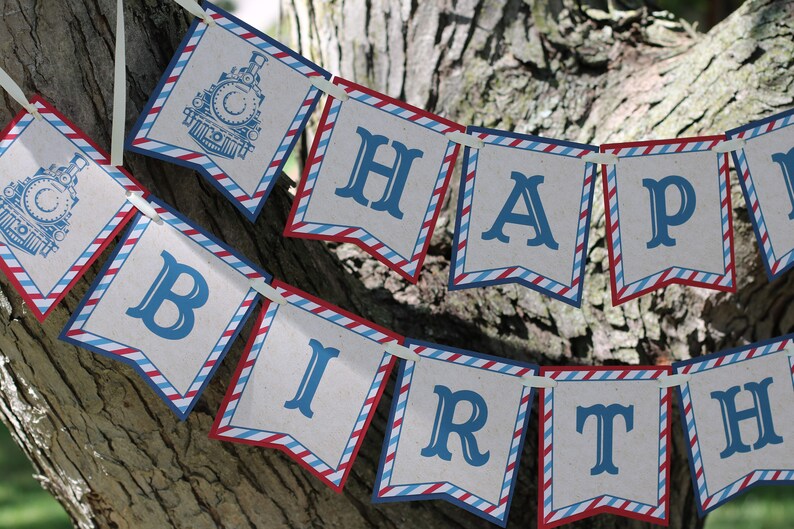 May include: A red, white, and blue banner with the words "Happy Birthday" in blue letters. The banner is decorated with a train theme.