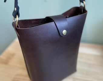 Leather cross body bag with adjustable strap.