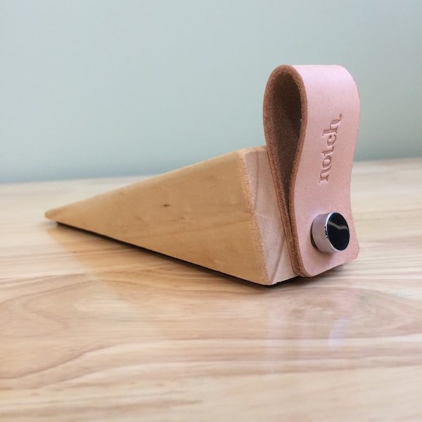 Door stopper, door wedge, or door jam, minimalist design made from leather and wood.