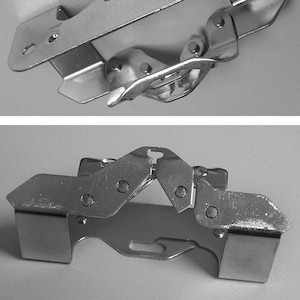 May include: A silver metal clamp with a hinged design. The clamp is open in the top image and closed in the bottom image.