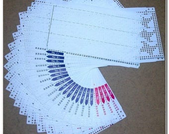 May include: A set of 20 white plastic knitting stitch markers with numbers 1 through 20 printed on them. The markers are arranged in a fan shape.