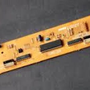 May include: A close-up of a yellow circuit board with black components and wires. The board has a label that reads "MODEL L500CT".