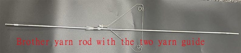 May include: A silver yarn rod with two yarn guides. The text "Brother yarn rod with the two yarn guide" is visible in the image.