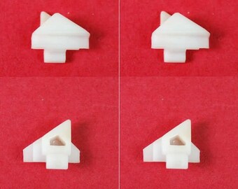 May include: Four white plastic corner protectors with a small grey dot in the centre of each. The protectors are designed to protect corners from damage.