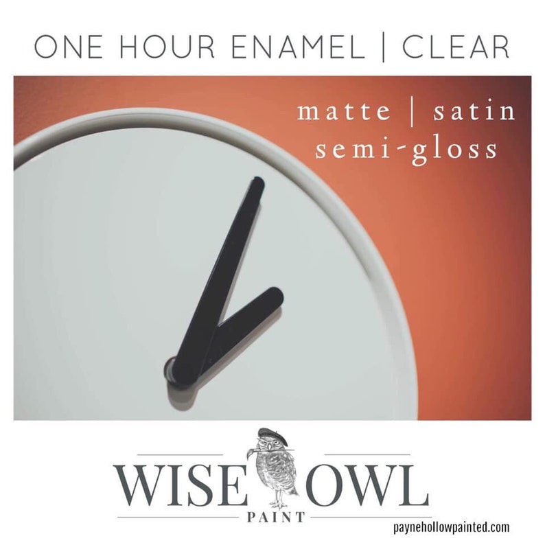 May include: A white clock face with black hands, set against an orange background. Text at the top reads "ONE HOUR ENAMEL | CLEAR". Below the clock face, the text reads "matte | satin semi-gloss". The Wise Owl Paint logo is at the bottom.