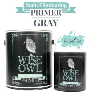 May include: Two black paint cans with the text "WISE OWL Stain Eliminating PRIMER GRAY". The cans feature a detailed illustration of an owl wearing a hat. The text "Stain Eliminating PRIMER" is written on a banner.