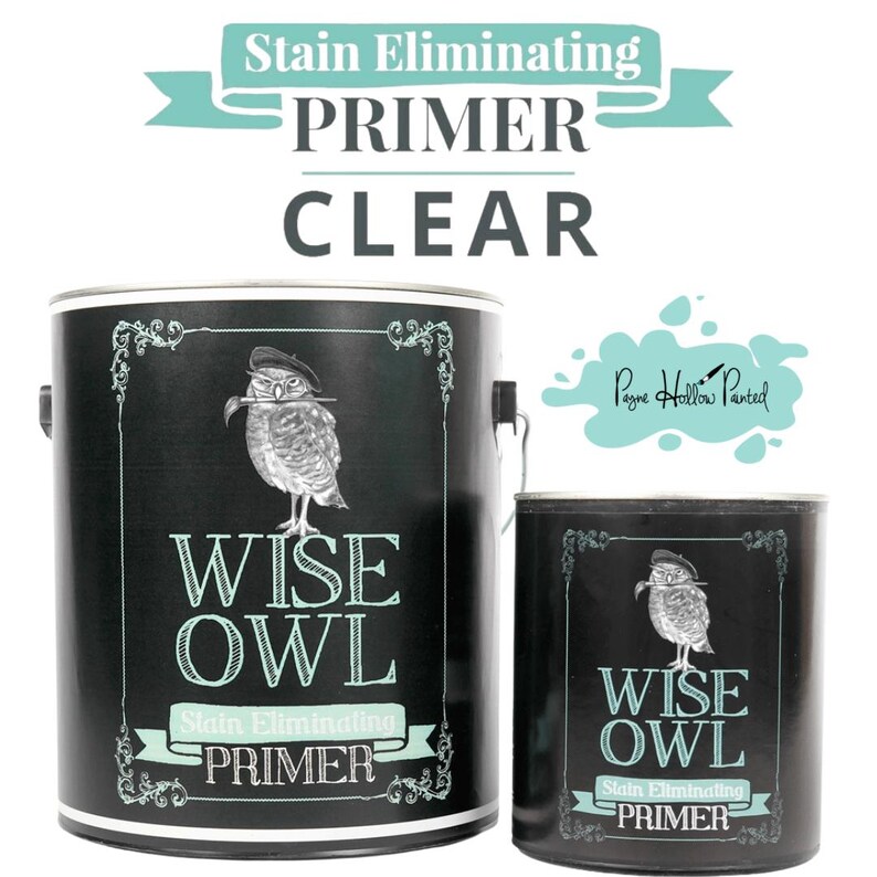 May include: Two black paint cans with the text "WISE OWL Stain Eliminating PRIMER CLEAR". The cans feature a drawing of an owl wearing a hat. The text "Stain Eliminating PRIMER" is in a teal banner.
