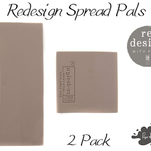 May include: Two gray rectangular foam pads labeled "re.design" with the text "DIY SIMPLIFIED" and "ANIRS HTIW" on the front. The pads are labeled "2 Pack".