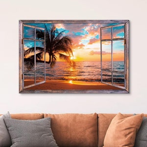 May include: A framed canvas print of a sunset over the ocean with a palm tree in the foreground. The image is framed to look like a window, with the window panes visible.