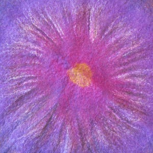 May include: A textured fiber art piece featuring a vibrant purple and magenta radial pattern that radiates outward from a central golden yellow circular core. The surface displays a soft, fuzzy, and fibrous appearance with blended color transitions.