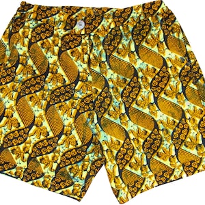 Puede incluir: Pantalones cortos de color amarillo y negro con un diseño ondulado. La tela tiene un patrón floral.