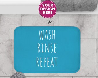 May include: A blue bath mat with the text "WASH RINSE REPEAT" in white.