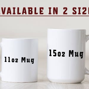 May include: Two white ceramic mugs with black text. The smaller mug says "11oz Mug" and the larger mug says "15oz Mug".