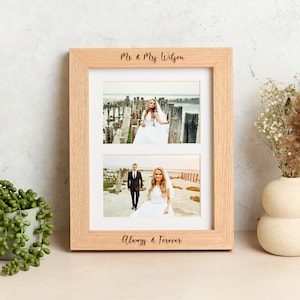 May include: A light-coloured wooden picture frame with two photo slots. The top of the frame reads "Mr & Mrs Wilson" and the bottom reads "Always & Forever". The frame contains two wedding photos.