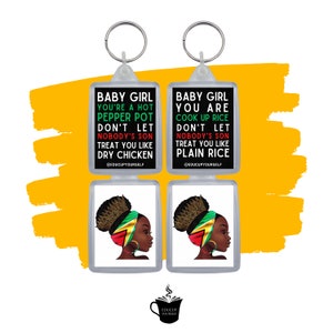 May include: Two black and white keychains with a black background and white text. The text on the left keychain reads "Baby Girl You're a Hot Pepper Pot Don't Let Nobody's Son Treat You Like Dry Chicken @EDUCUPYOURSELF". The text on the right keychain reads "Baby Girl You Are Cook Up Rice Don't Let Nobody's Son Treat You Like Plain Rice @EDUCUPYOURSELF". Both keychains feature a black and green illustration of a woman with a head wrap.