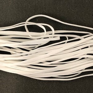 May include: A white elastic cord, wound into a coil, for crafting and sewing projects.