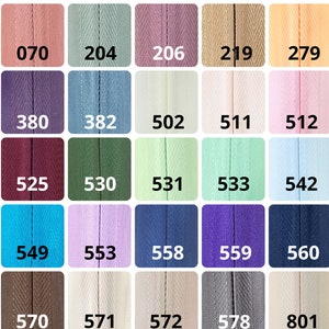 May include: A color chart with 24 different colors of fabric ribbon. The colors include shades of pink, blue, green, purple, brown, and beige. Each color is labeled with a number.