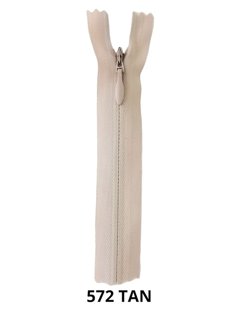 May include: A tan zipper with a plastic slider. The zipper is closed and the slider is in the up position. The zipper is labeled "572 TAN".