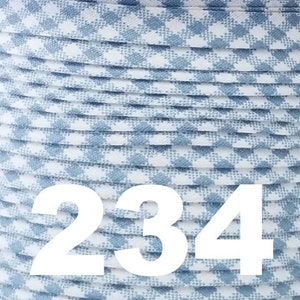 May include: A close-up of a spool of blue and white gingham ribbon. The ribbon is wound tightly and the number 234 is printed on the front of the spool.