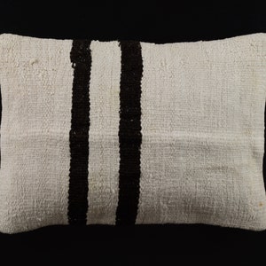 May include: White pillow with two black stripes down the centre.