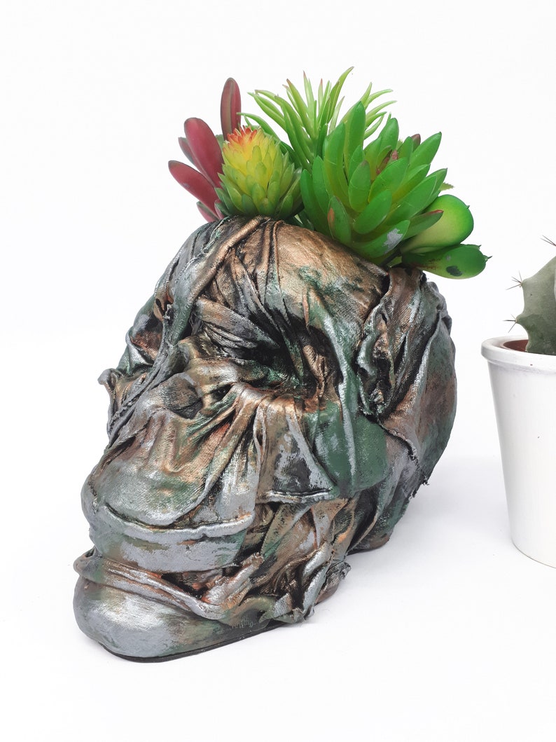 Large Skull pot complete with faux succulents