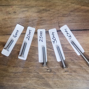 May include: Five silver screws of varying lengths, labelled with their measurements in millimetres: 16mm, 20mm, 25mm, 30mm, and 40mm.