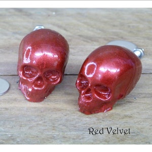 May include: Two red velvet skull-shaped drawer pulls with silver hardware. The text "Red Velvet" is printed below the pulls.