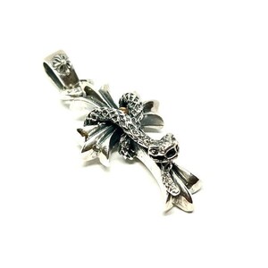 May include: A silver pendant featuring a cross with a snake wrapped around it. The pendant has a detailed design and is a statement piece.