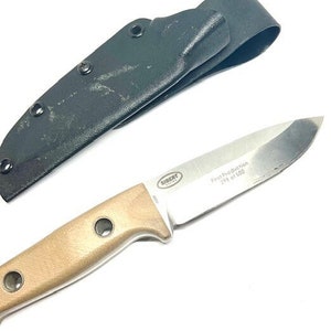 May include: A brown leather sheath with a black snap closure and a silver knife with a brown handle. The knife has the text "First Production 198 of 500" and "SIBERT" engraved on the blade.
