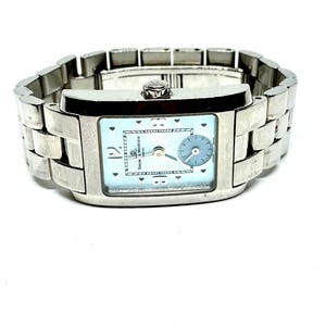 May include: A silver-toned wristwatch with a rectangular face and a light blue dial. The watch features a small subdial and a linked metal band. The watch face has the brand name "Baume & Mercier".