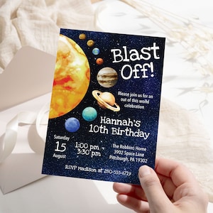 May include: A blue and black space-themed birthday invitation with a watercolor illustration of the sun and planets. The text reads "Blast Off!" and "Hannah's 10th Birthday". The invitation includes the date, time, location, and RSVP information.