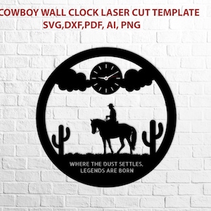 May include: Black laser-cut wall clock featuring a cowboy on horseback, cacti, and a clock face. The text "WHERE THE DUST SETTLES, LEGENDS ARE BORN" is included. The clock is a circular design with a western theme.