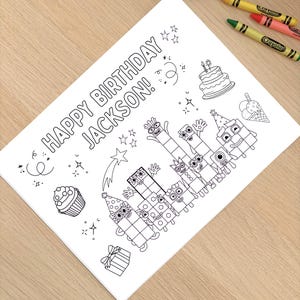 May include: A black and white coloring page with the text "HAPPY BIRTHDAY JACKSON!" and illustrations of a cake, cupcakes, and Numberblocks characters. Crayola crayons in purple, yellow, green, and red are scattered around the page.