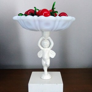 Vintage milk glass pedestal dish. Charming Cherub holding white milk glass candy dish. Vintage vanity accent. Trinket dish, jewlery catch.
