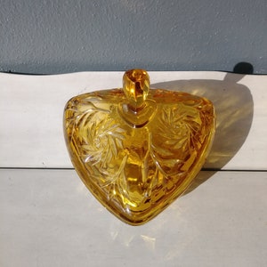 Amber glass triangle shaped candy dish with lid.