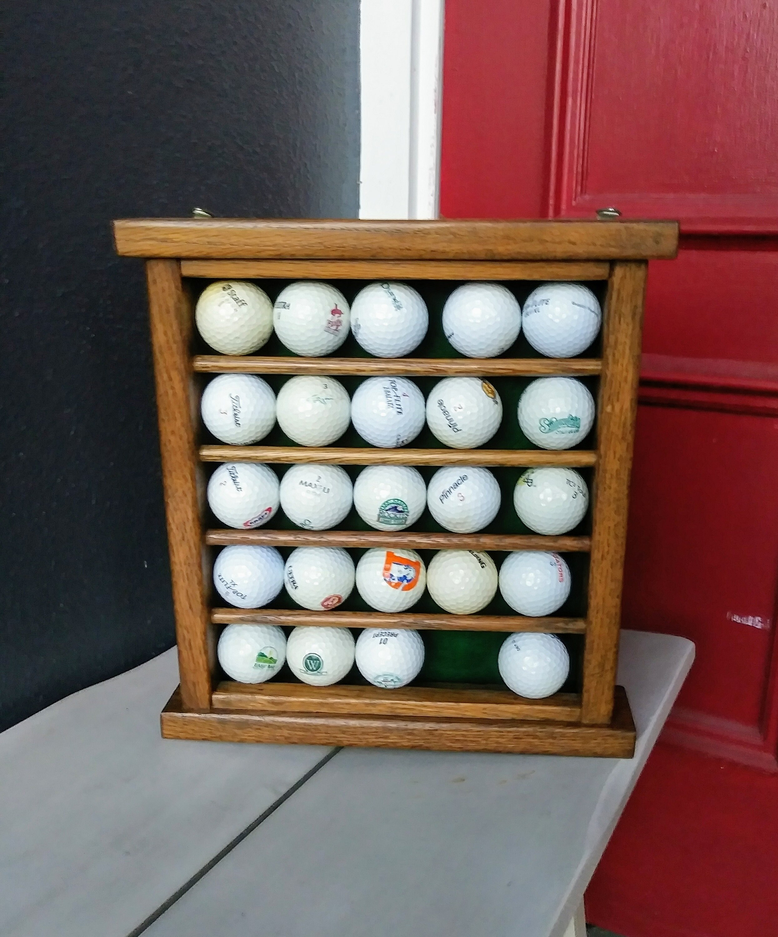 Golf ball rack and 24 assorted collectable golf balls. Etsy