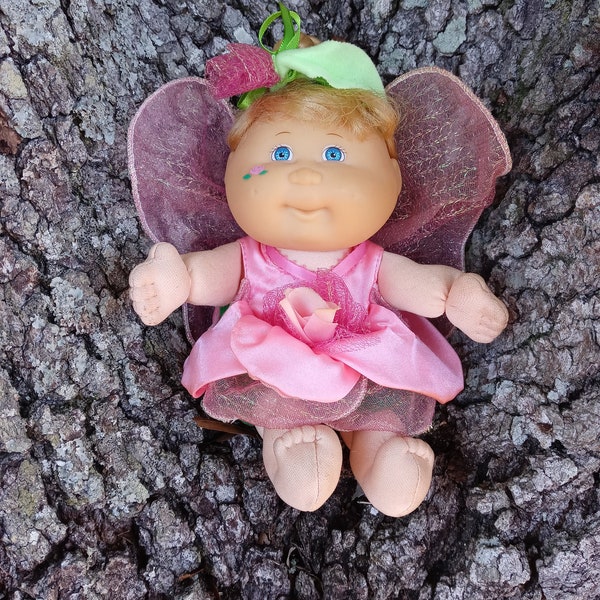 Vintage Cabbage Patch Kid Garden Fairy Rose doll. Small plush doll in rose dress with pink fairy wings.