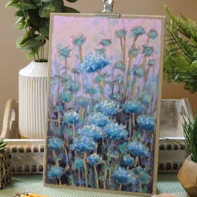 A floral piece with a soft colour scheme of blues flowers and pinks in the background.  An ideal artwork for creating a calm space.