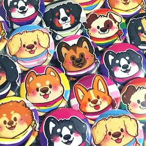 May include: A selection of round, glossy buttons with cartoon dogs wearing pride flag bandanas. The buttons are in shades of pink, blue, yellow, and purple. The dogs are of various breeds and have different expressions. The buttons are a vibrant collection.