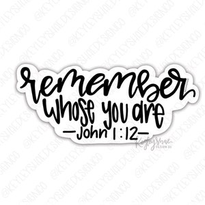 May include: A white sticker with black text that reads "remember whose you are - John 1:12". The sticker has a black border and a handwritten font. The sticker is on a white background with a watermark.