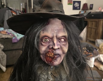 May include: A creepy, detailed, hand-painted, zombie witch bust with a black witch hat, long black hair, and a torn, tattered, lace collar.