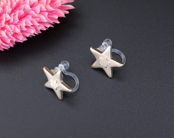 SPICA | Boucles d'oreilles clip avec étoiles dorées | Bijou céleste | Puces sans piercing